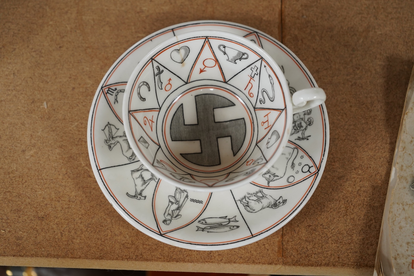 A Royal Doulton 'The Egyptian Divining cup and saucer', with booklet, numbered RN543665